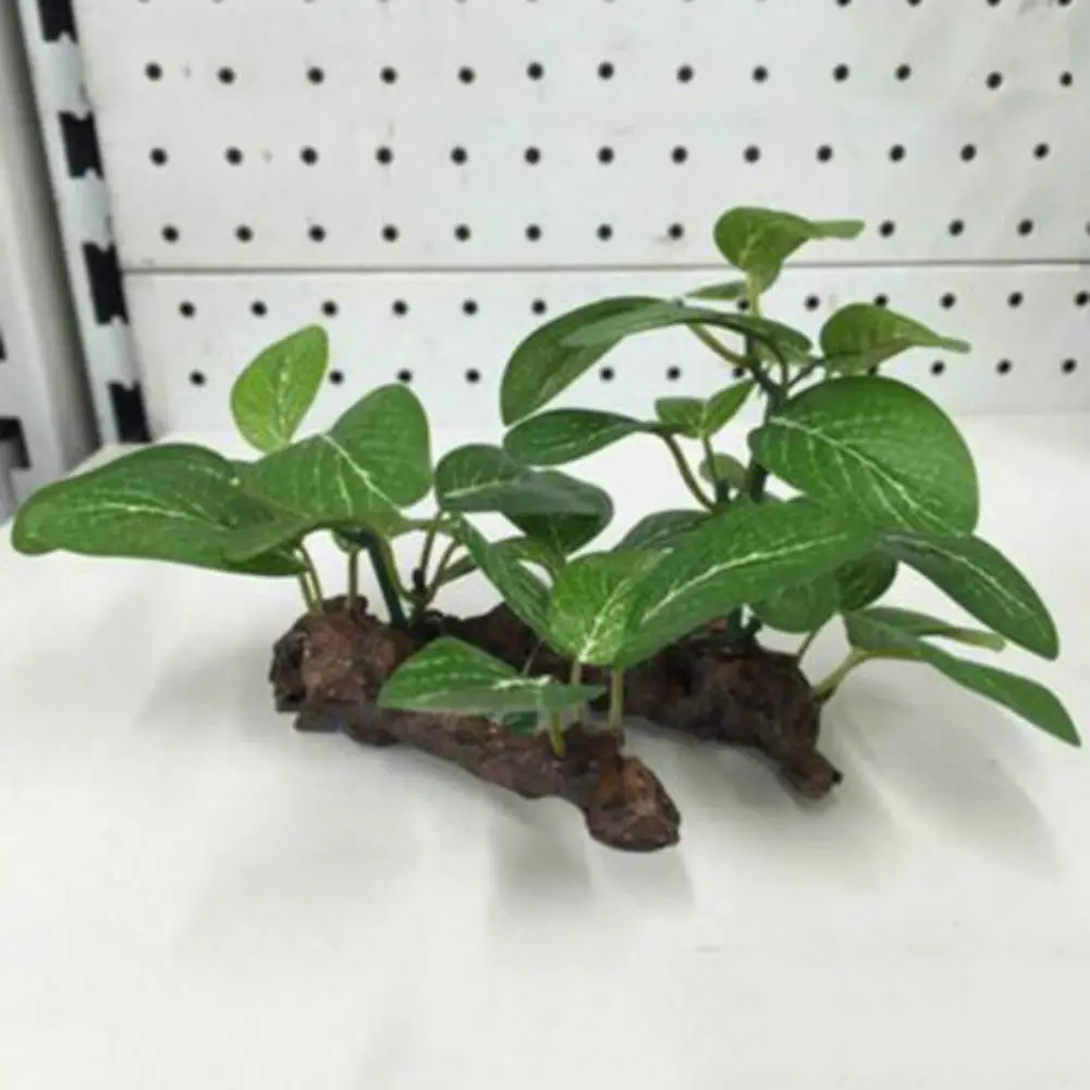 Set of realistic artificial aquarium plants anchored on a faux wood base in a fish tank