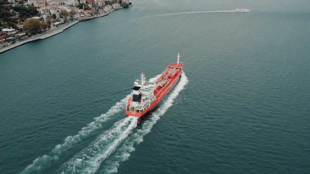 Aerial shot of a red cargo ship navigating the Bosphorus Strait near Istanbul, Turkey.